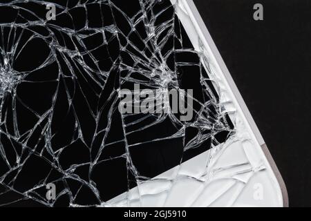 Broken display screen. Damaged smartphone glass. Closeup, dark background, selective focus Stock Photo