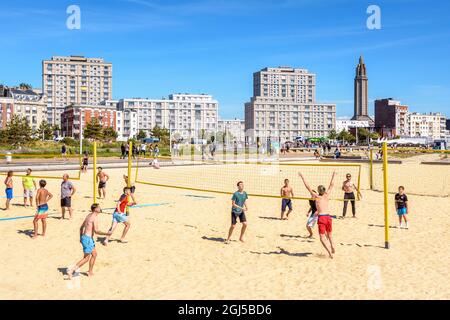 Beach volleyball and the 'Porte Oceane' building complex in Le Havre, France. Stock Photo