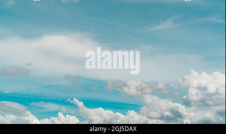 Cloudscape of white stratocumulus clouds on blue sky. Full Frame of white fluffy clouds texture background. Heaven sky with daylight. Beauty in nature Stock Photo