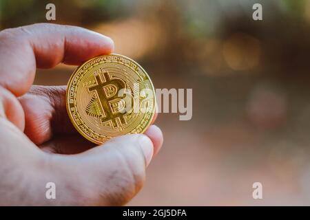 Brazil. 08th Sep, 2021. In this photo illustration a man displays a gold Bitcoin. Credit: SOPA Images Limited/Alamy Live News Stock Photo