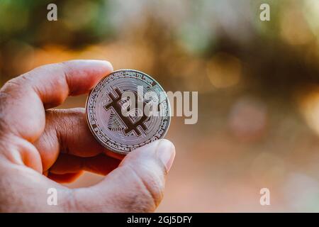 Brazil. 08th Sep, 2021. In this photo illustration a man displays a silver Bitcoin. Credit: SOPA Images Limited/Alamy Live News Stock Photo