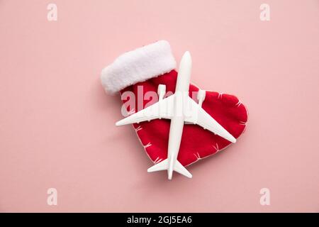 Christmas travel background. model of an airplane with a festive stocking  Stock Photo - Alamy