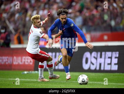 England's Jack Grealish (right) and Poland's Kamil Jozwiak during the 2022 FIFA World Cup Qualifying match at PGE Narodowy Stadium, Warsaw. Picture date: Wednesday September 8, 2021. Stock Photo