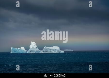 Antarctica, South Georgia Island. Horizontal rainbow and icebergs. Credit as: Don Grall / Jaynes Gallery / DanitaDelimont.com Stock Photo