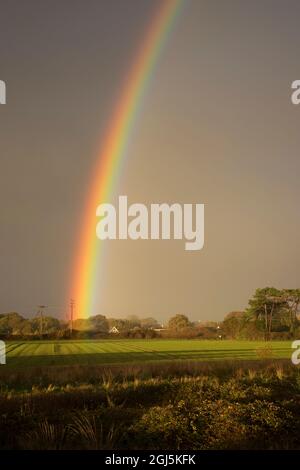 Double rainbow in stormy sky over Rook Farm,Hayling Island, Hampshire UK Stock Photo