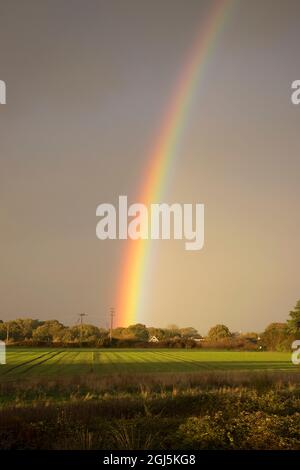 Double rainbow in stormy sky over Rook Farm,Hayling Island, Hampshire UK Stock Photo