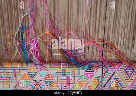 Bhutan, Thimphu. Traditional colorful and ornate hand woven textile on loom. Stock Photo
