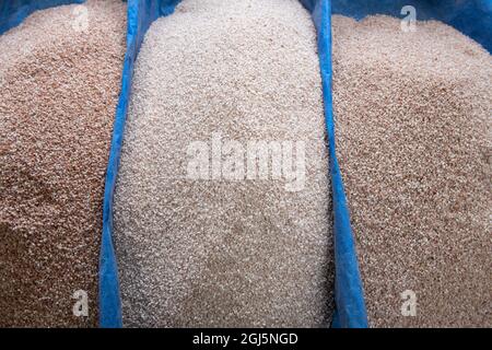 Bhutan, Thimphu. Local Farmer's Market. Detail of rice vendor display showing different varieties, including traditional red rice. Stock Photo