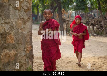 Young monk boys walking in a small town outside Bagan, Myanmar. Stock Photo