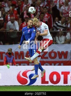 England's Luke Shaw and Poland’s Kamil Jozwiak (right) battle for the ball during the 2022 FIFA World Cup Qualifying match at PGE Narodowy Stadium, Warsaw. Picture date: Wednesday September 8, 2021. Stock Photo