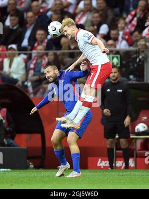 England's Luke Shaw and Poland’s Kamil Jozwiak (right) battle for the ball during the 2022 FIFA World Cup Qualifying match at PGE Narodowy Stadium, Warsaw. Picture date: Wednesday September 8, 2021. Stock Photo