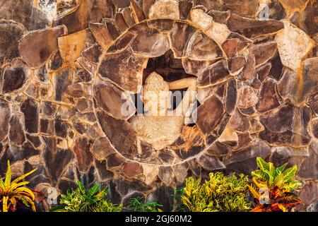 Statue of a Balinese woman and tropical foliage, Bali, Indonesia Stock Photo