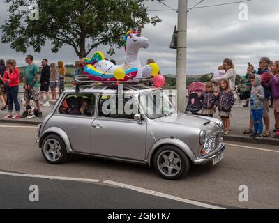 BIDEFORD, NORTH DEVON, ENGLAND - AUGUST 30 2021: Classic mini cars in The Legendary Grand Tour supporting Children's Hospice SW. Fancy dress day, here Stock Photo