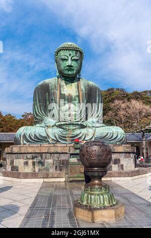 The Great Buddha, Daibutsu, with the incense burner in front, blue sky above in Kamakura, Japan Stock Photo