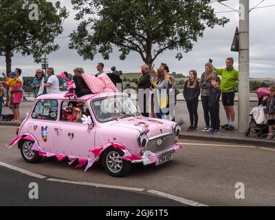 BIDEFORD, NORTH DEVON, ENGLAND - AUGUST 30 2021: Classic mini cars in The Legendary Grand Tour supporting Children's Hospice SW. Fancy dress day. Stock Photo