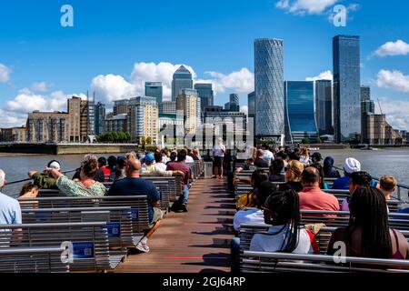 A Cruise Boat On The River Thames Approaches Canary Wharf, London, Uk. Stock Photo