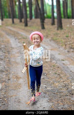 The girl is carrying a music stand for drawing. Stock Photo