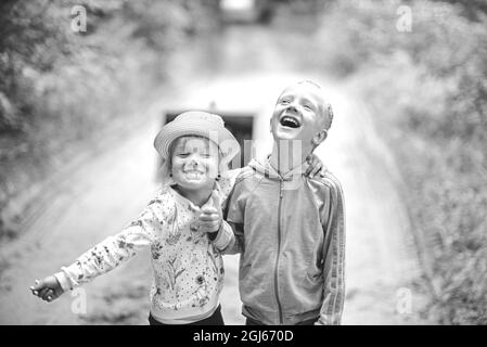 Portrait of joyful children. Happy Boy and Girl. B W photo Stock Photo