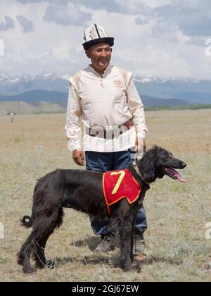 Breeders of Kyrgyz hunting dog, Taigan, during a competition. Folk