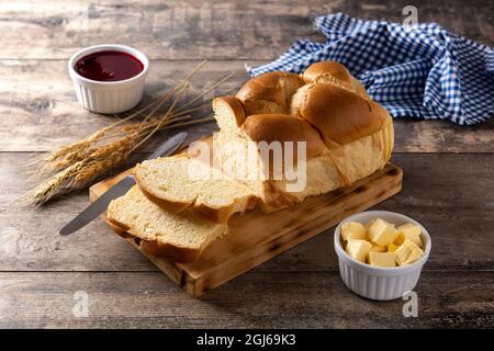 Braided egg bread on wooden table Stock Photo