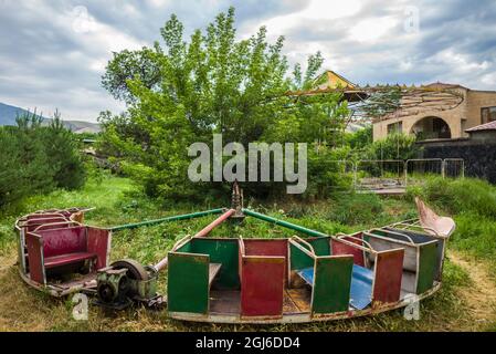 Armenia, Yeghegnadzor. Abandoned carousel in amusement park. Stock Photo