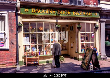 man window shopping shopper at Baggins Book books Bazaar shop Rochester high street Kent Uk Stock Photo