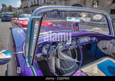 View into driver's seat of classic convertible purple American Pontiac parked in Vieja, old Habana, Havana, Cuba. Stock Photo