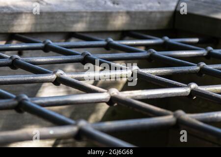 detail of a massive decorative lattice over a well formed by squares Stock Photo