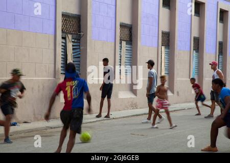 Local Cuban children playing soccer and basketball in the streets of Old Havana, Cuba. Stock Photo