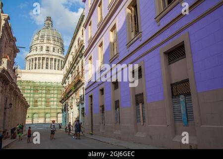 Local Cuban children playing soccer and basketball in the streets of Old Havana, Cuba. Capital building in background. Stock Photo