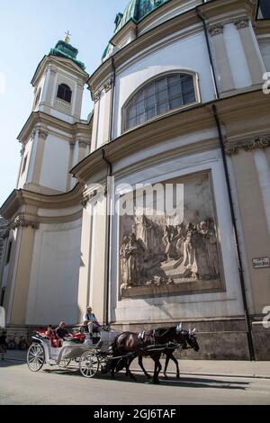 Europe, Austria, Vienna, Inner City (UNESCO World Heritage Site), A Fiaker (carriage) in front of a Bas Relief at St. Peter's Church (Editorial Use On Stock Photo