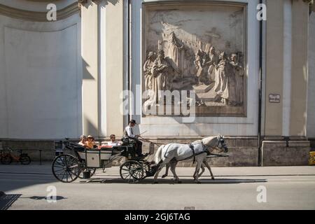 Europe, Austria, Vienna, Inner City (UNESCO World Heritage Site), A Fiaker (carriage) in front of a Bas Relief at St. Peter's Church (Editorial Use On Stock Photo