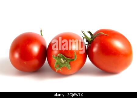 Three tomatoes isolated on white background. Stock Photo