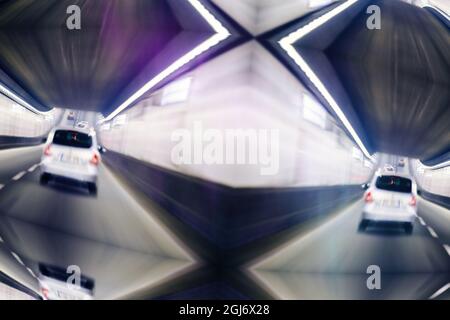 Rear view of white car driving fast in tunnel Stock Photo