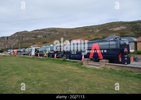 Team Buses gathered on West Shore, Llandudno for the finish of the Tour of Britain 2021 Stage 4 Stock Photo