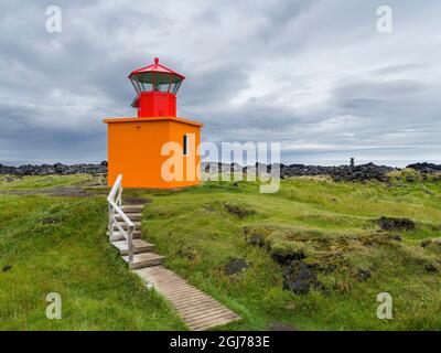 Lava flow at coast with lighthouse at Oendverdarnes. Landscape on peninsula Snaefellsnes in western Iceland. (Editorial Use Only) Stock Photo