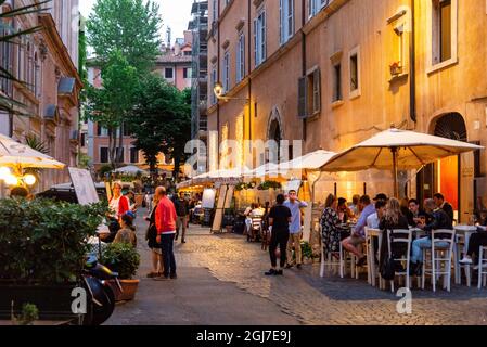 Italy, Rome. Via del Teatro Pace, outdoor diners.