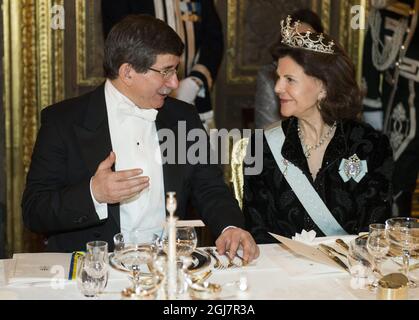 Turkiets Foreign Minister Ahmet Davutoglu, left, talks to Sweden's Queen Silvia ahead of a gala dinner at the Stockholm Palace on March 11, 2013. Turkish President Abdullah Gul arrived with his delegation to Sweden on Monday for a three-day official state visit.      Stock Photo