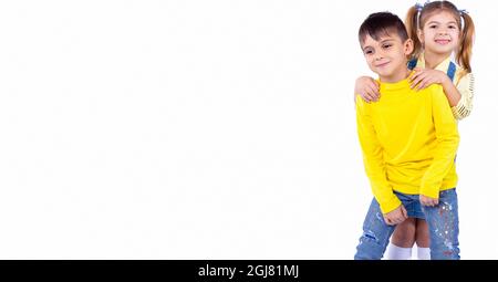 The sister standing behind her brother, they are making fun and spending the time very joyfully together. Stock Photo