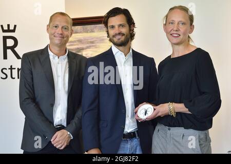 STOCKHOLM 20130812 Prince Carl Philip stands behind the idea and concept development of 'The Swedish Red List,' a new series of plates and bowls from porcelain maker Rorstrand presented on Monday, August 12, 2013. Designer Anna Lerinder (right) and illustrator Stefan Horberg created the series with images of endangered Swedish plants and animals. Foto: Henrik Montgomery / SCANPIX / kod: 10060  Stock Photo