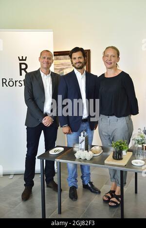 STOCKHOLM 20130812 Prince Carl Philip stands behind the idea and concept development of 'The Swedish Red List,' a new series of plates and bowls from porcelain maker Rorstrand presented on Monday, August 12, 2013. Designer Anna Lerinder (right) and illustrator Stefan Horberg created the series with images of endangered Swedish plants and animals. Foto: Henrik Montgomery / SCANPIX / kod: 10060  Stock Photo