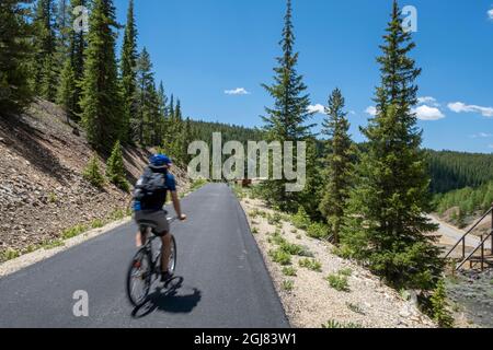 Biking, Mineral Belt Trail through the historic mining district of Leadville active at the turn of the century, Colorado, USA. Stock Photo