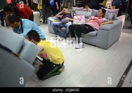KINA 2013-09-27 Customers at an IKEA furniture store in China September, 2013. Customers falling asleep in the beds and sofas of IKEA are not unusual in China. But thatÂ’s not a problem according to the IKEA management -We welcome all who want to come to our stores. All our visitors are potential customers, said Linda Xu, public relations for the the Ikea grouo in China, according to Swediosh newspaper DN, quting Le Figaro. Since Ikea established itself in China 15 years ago, the country has become one of their most important markets. Nearly 15 million people visited the 11 stores in China la Stock Photo