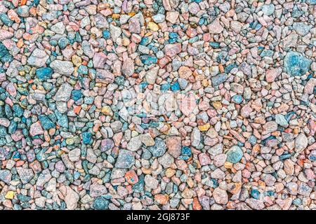 The texture of small crushed stone of different colors, on which asphalt is laid on top during road works Stock Photo