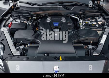 Ukraine, Odessa - September 8, 2021: Maserati Ghibli, close-up of the V6 engine of the modern luxury car, front view. Internal combustion engine, car parts, deteyling. Stock Photo