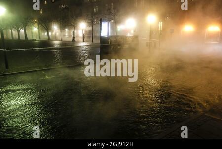 LUND 20150206 Mist from the water leaked from the district heating system outside the train station in Lund in southern Sweden February 6, 2015. Police roped of central Lund after the leak, but one person was killed when a bus on its way out from the flooded area collided with a man in the mist from the heated water. The temperature of the leaking water was 88 degrees Celsius. Photo: Stig-Ake Jonsson / TT ** SWEDEN OUT ** Stock Photo