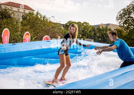 Hanover, Germany. 09th Sep, 2021. Nadine surfs under instruction in a temporary surfing facility on the Opernplatz in the city centre. Credit: Moritz Frankenberg/dpa/Alamy Live News Stock Photo