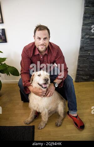 ORNSKOLDSVIK 2015-03-23 Former stray dog Arthur is seen relaxing with his new family, owner Mikael Lindnord, Helena Lindnord and daughter Philippa in his new home in Ornskoldsvik, North Sweden March 23, 2015. Arthur and Mikael Lindnord, member of the Swedish Multi Sport team, met during a lunch break in a small village in Ecuador in November 2014. Lindnord gave him a meatball and after that they became inseparable. Arthur followed the team everywhere for the rest of the multi-sport race and Lindnord decided to adopt Arthur and the dog will now live the rest of his life in Sweden. Foto: Nora L Stock Photo