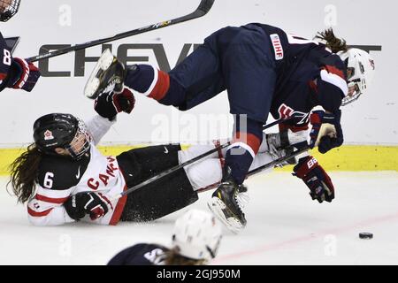 Canada's Rebecca Johnston, left, clashes with US Alex Carpenter during the 2015 IIHF Ice Hockey Women's World Championship group A match between USA and Canada at Malmo Isstadion in Malmo, southern Sweden, on March 28, 2015. Photo: Claudio Bresciani / TT / code 10090  Stock Photo