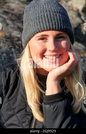 Sweden, West Coast, Uddevalla. Young Swedish woman enjoying autumn sunshine. (MR) Stock Photo
